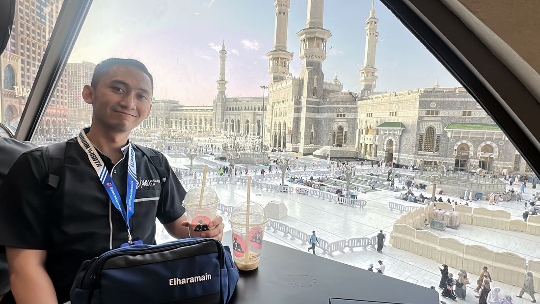 Adryan seated at a window overlooking the Grand Mosque in Makkah