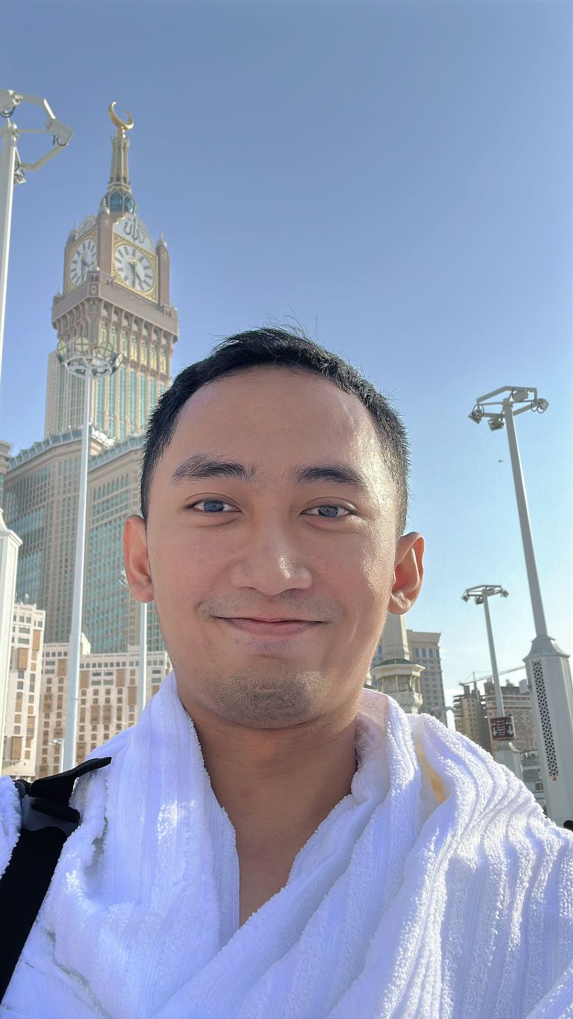 Adryan in white with the Makkah clock tower behind him